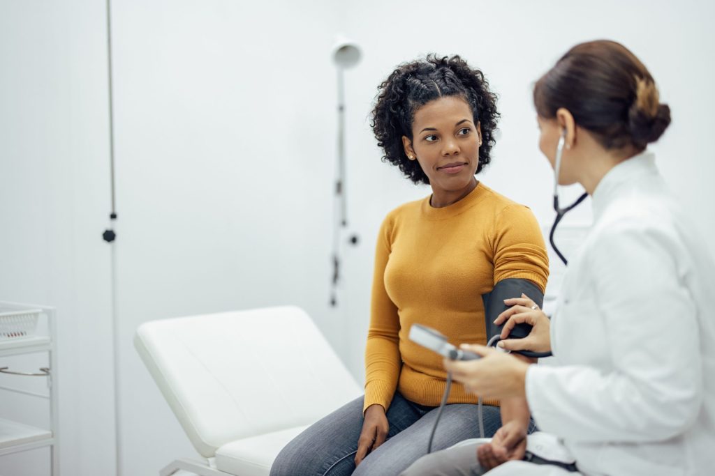 woman getting blood pressure taken