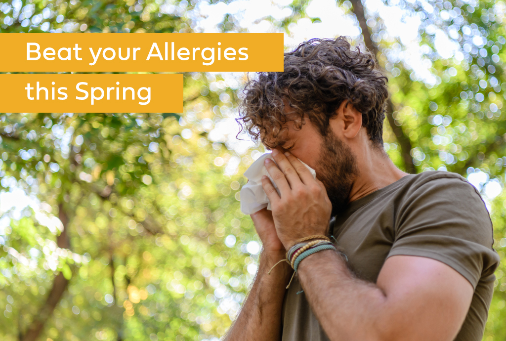 Man sneezing due to allergies